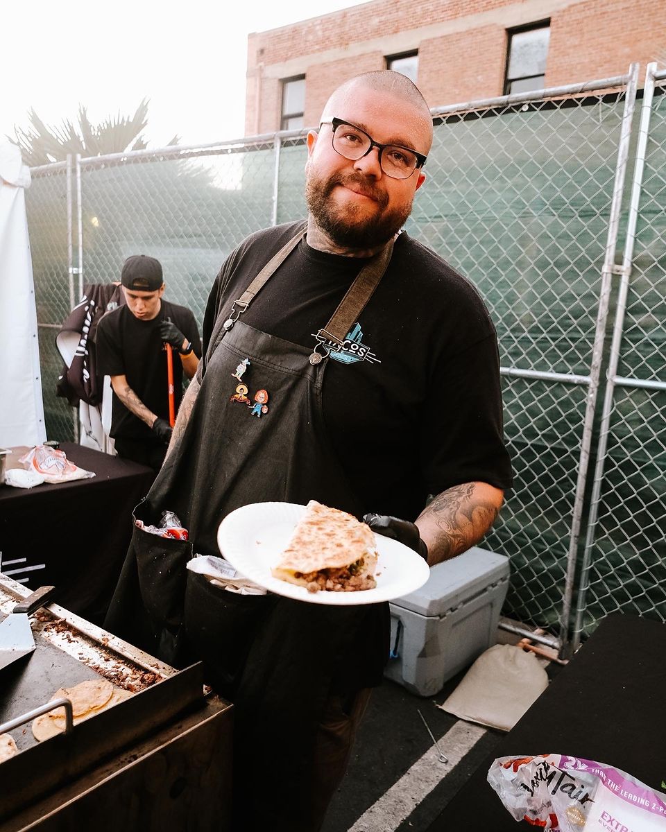 Chef serving a plated dish at a catered event